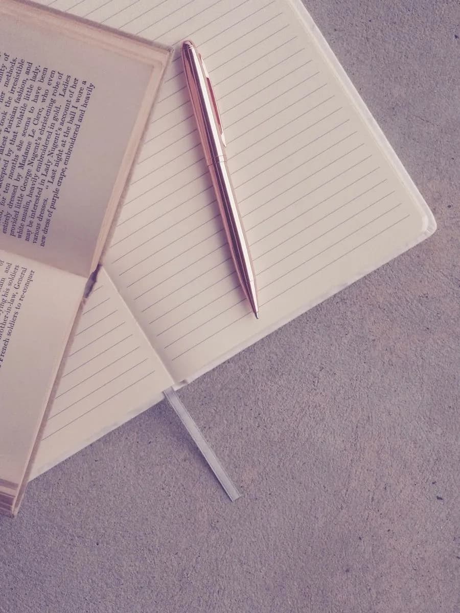 Book and notebook on an academic desk
